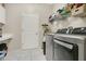 Modern laundry room with side-by-side washer and dryer and wire shelving at 4002 Richmond Xing, Leesburg, FL 34748