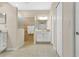 Bright main bathroom featuring a walk-in shower, vanity, and a linen closet at 4002 Richmond Xing, Leesburg, FL 34748
