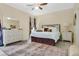 Relaxing main bedroom with a ceiling fan, natural light, and stylish decor at 4002 Richmond Xing, Leesburg, FL 34748