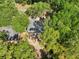 A charming home, viewed from above, is nestled among mature trees in a tranquil residential neighborhood, offering serene privacy at 5 Pecan Drive Crse, Ocala, FL 34472