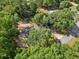 An aerial view of a charming single-story home surrounded by lush greenery, set on a spacious lot with a long driveway at 5 Pecan Drive Crse, Ocala, FL 34472