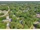 Aerial shot displays the serene community, featuring houses nestled among trees and winding roads at 5 Pecan Drive Crse, Ocala, FL 34472