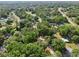 Aerial view highlights the neighborhood, showcasing its layout with mature trees and residential properties at 5 Pecan Drive Crse, Ocala, FL 34472