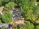 Overhead view of a single-story home surrounded by mature trees, set back from the road with a long driveway, in a residential area at 5 Pecan Drive Crse, Ocala, FL 34472
