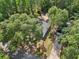 Aerial shot of the charming single-Gathering home nestled among lush green trees, showcasing its spacious layout and serene setting at 5 Pecan Drive Crse, Ocala, FL 34472