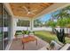 The back porch offers an outdoor seating area with a wooden ceiling overlooking the fenced yard at 5 Pecan Drive Crse, Ocala, FL 34472