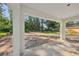 Covered outdoor patio overlooking a wooded backyard, perfect for enjoying nature at 5 Pecan Drive Crse, Ocala, FL 34472