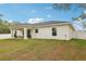 View of the newly constructed home featuring a large, fenced backyard with an outdoor seating area at 5 Pecan Drive Crse, Ocala, FL 34472