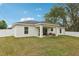 A spacious, newly sodded backyard with a covered patio is enclosed with a white privacy fence at 5 Pecan Drive Crse, Ocala, FL 34472