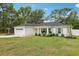 Landscaped front yard of a well-maintained one-story home with a two-car garage at 5 Pecan Drive Crse, Ocala, FL 34472