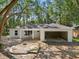 Newly built home with modern design elements, integrated garage, and situated within a wooded area at 5 Pecan Drive Crse, Ocala, FL 34472
