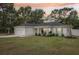 Charming one-story home boasts a manicured lawn, attached garage, and welcoming front porch at sunset at 5 Pecan Drive Crse, Ocala, FL 34472