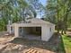 New construction featuring white exterior, attached garage, and is set on a partially wooded lot at 5 Pecan Drive Crse, Ocala, FL 34472