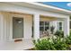 Inviting front porch offers a seating area and a welcoming painted front door at 5 Pecan Drive Crse, Ocala, FL 34472