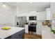 Modern kitchen with stainless steel appliances, a center island, and white shaker cabinets at 5 Pecan Drive Crse, Ocala, FL 34472