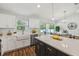 Well-lit kitchen with island seating, modern white cabinets, and stainless steel dishwasher at 5 Pecan Drive Crse, Ocala, FL 34472