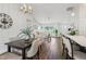 Bright living room with wood floors, comfortable seating, and dining area, illuminated by stylish pendant lighting at 5 Pecan Drive Crse, Ocala, FL 34472