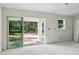 Bright living room with sliding glass doors leading to the backyard and large windows at 5 Pecan Drive Crse, Ocala, FL 34472