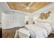 Bright main bedroom featuring a decorative wood ceiling, fan, and connecting bathroom at 5 Pecan Drive Crse, Ocala, FL 34472