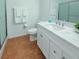 Clean, bright bathroom featuring a white marble countertop, ample storage, and a glass-enclosed shower at 5371 Lonesome Dove Dr, Kissimmee, FL 34746