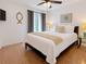 Bright bedroom featuring a ceiling fan, decorative art, and a comfortable queen-sized bed with white linens at 5371 Lonesome Dove Dr, Kissimmee, FL 34746