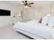 Spacious primary bedroom featuring a large bed, ceiling fan, walk-in closet and en-suite bath at 5371 Lonesome Dove Dr, Kissimmee, FL 34746