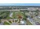 An aerial view showcases the home's location near green spaces, ponds, and the city at 7 Madeira Ave, Orlando, FL 32825