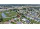 An aerial view showcases the home's location near green spaces, ponds, and the city at 7 Madeira Ave, Orlando, FL 32825