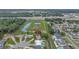 An aerial view shows the property with a private pool in a neighborhood with mature trees and stormwater ponds nearby at 7 Madeira Ave, Orlando, FL 32825