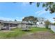 Spacious backyard with mature trees, trampoline, shed, and plenty of space for outdoor activities at 7 Madeira Ave, Orlando, FL 32825