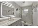 A modern bathroom features marble tiles and a glass-enclosed shower at 7 Madeira Ave, Orlando, FL 32825