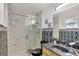 Elegant bathroom featuring a glass shower, stylish vanity, black toilet, and unique tile work at 7 Madeira Ave, Orlando, FL 32825