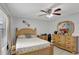 Inviting bedroom with warm tones, wood floors, a ceiling fan, and a window at 7 Madeira Ave, Orlando, FL 32825