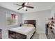 A cozy bedroom with wood-look flooring, a ceiling fan and closet at 7 Madeira Ave, Orlando, FL 32825