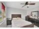 A cozy bedroom with wood-look flooring, a ceiling fan and closet at 7 Madeira Ave, Orlando, FL 32825