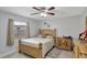 Comfortable bedroom featuring neutral walls, wood floors, a ceiling fan, and natural light at 7 Madeira Ave, Orlando, FL 32825