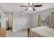 Well-lit bedroom with wood floors, gray walls, a closet, and a ceiling fan at 7 Madeira Ave, Orlando, FL 32825