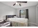 A stylish bedroom features a ceiling fan and wood-look floors at 7 Madeira Ave, Orlando, FL 32825