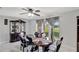 Bright dining room features a dark wood display case, dining table with seating for six, and large window at 7 Madeira Ave, Orlando, FL 32825