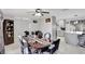 Elegant dining room boasts a modern ceiling fan, dark wood table with seating for six, and opens to the kitchen at 7 Madeira Ave, Orlando, FL 32825