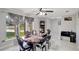 Bright dining room with a dark wood table, chairs, and a large window offering natural light at 7 Madeira Ave, Orlando, FL 32825