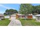 Charming single-story home with a well-maintained lawn, inviting curb appeal, and an attached garage at 7 Madeira Ave, Orlando, FL 32825