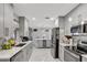 Modern, light gray kitchen is fully equipped with stainless steel appliances and ample counter space for cooking at 7 Madeira Ave, Orlando, FL 32825