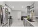Modern kitchen boasts stainless steel appliances, ample cabinet space, and a view into the living area at 7 Madeira Ave, Orlando, FL 32825