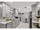 Bright kitchen features marble floors, modern appliances, gray cabinets, and an island with wine rack at 7 Madeira Ave, Orlando, FL 32825