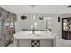 Charming kitchen island offers seating, pendant lights, and built-in wine rack, adjacent to dining and kitchen area at 7 Madeira Ave, Orlando, FL 32825