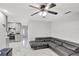 Bright living room featuring marble floors, gray walls, a ceiling fan, and an open floor plan at 7 Madeira Ave, Orlando, FL 32825