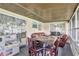 Relaxing screened patio with dining table and sitting area offers the perfect place for entertaining at 7 Madeira Ave, Orlando, FL 32825