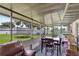 Relaxing screened patio with dining table and sitting area offers the perfect place for entertaining at 7 Madeira Ave, Orlando, FL 32825