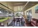 Relaxing screened patio with dining table and sitting area offers the perfect place for entertaining at 7 Madeira Ave, Orlando, FL 32825